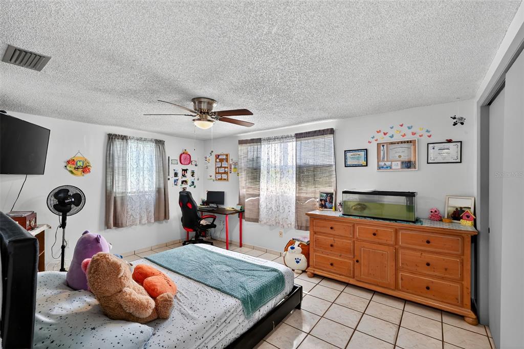 3837 Darlington Road Holiday, FL 34691 - Photo 16 of 28 a bedroom with a bed and dresser