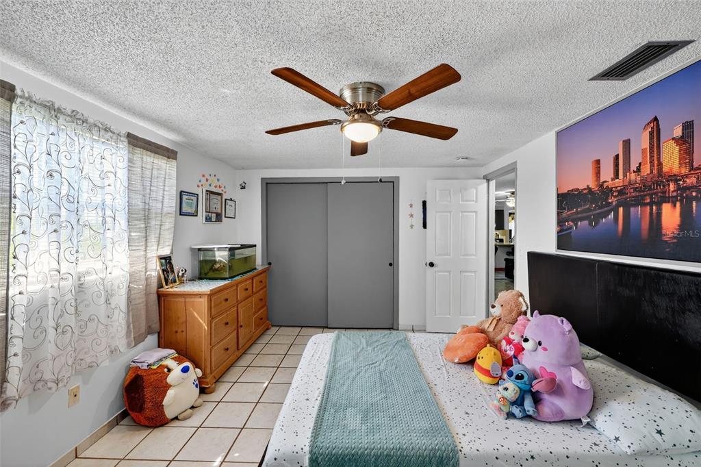 3837 Darlington Road Holiday, FL 34691 - Photo 17 of 28 a bed room with a bed and furniture