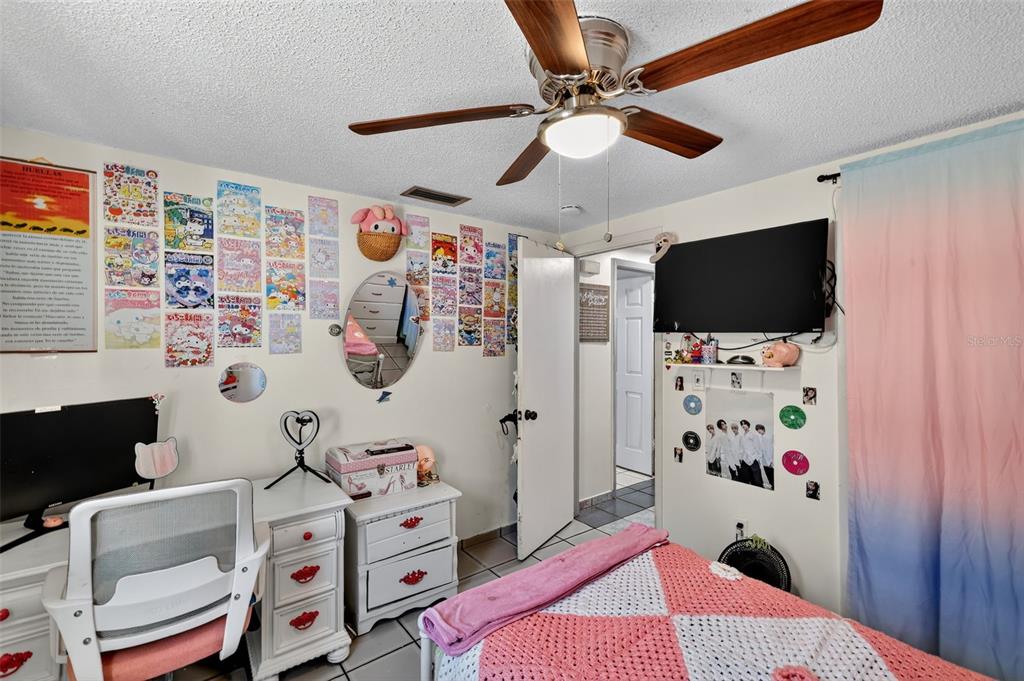 3837 Darlington Road Holiday, FL 34691 - Photo 19 of 28 a bedroom with a bed and a flat screen tv