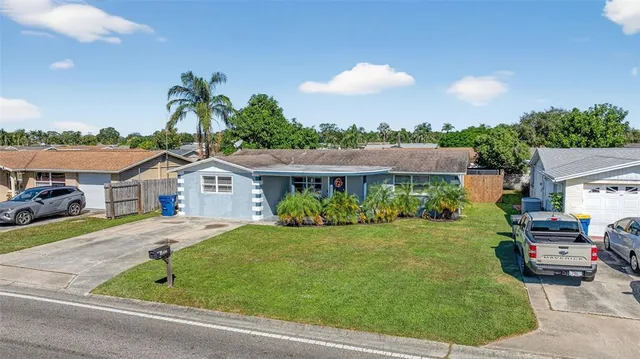 an aerial view of a house with a swimming pool yard and outdoor seating