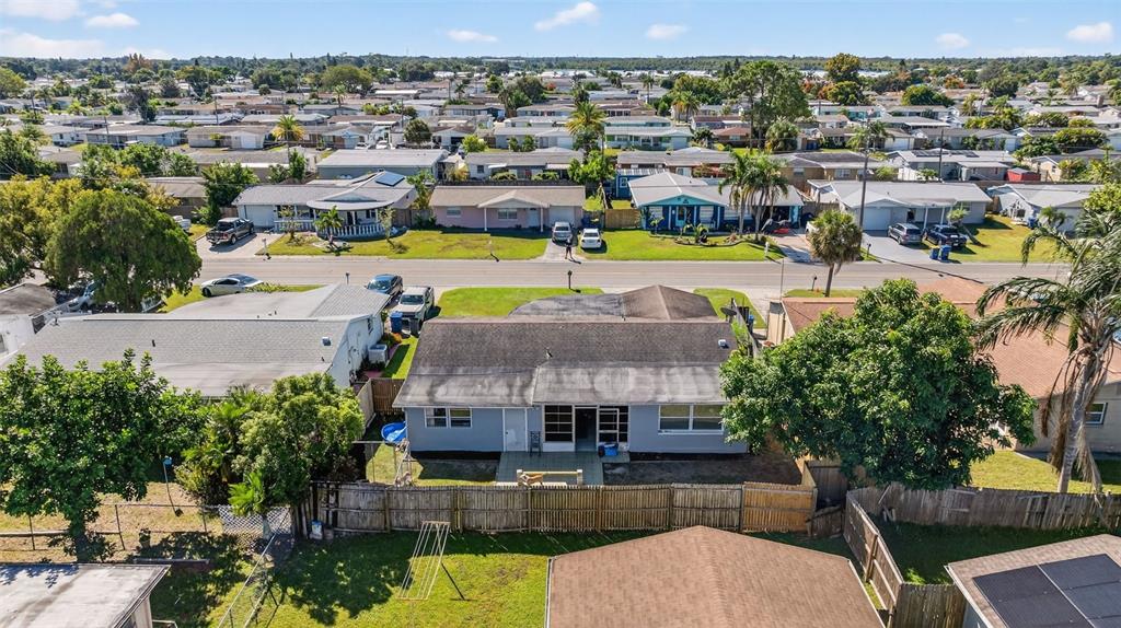 3837 Darlington Road Holiday, FL 34691 - Photo 26 of 28 an aerial view of a house with a swimming pool outdoor seating and yard view