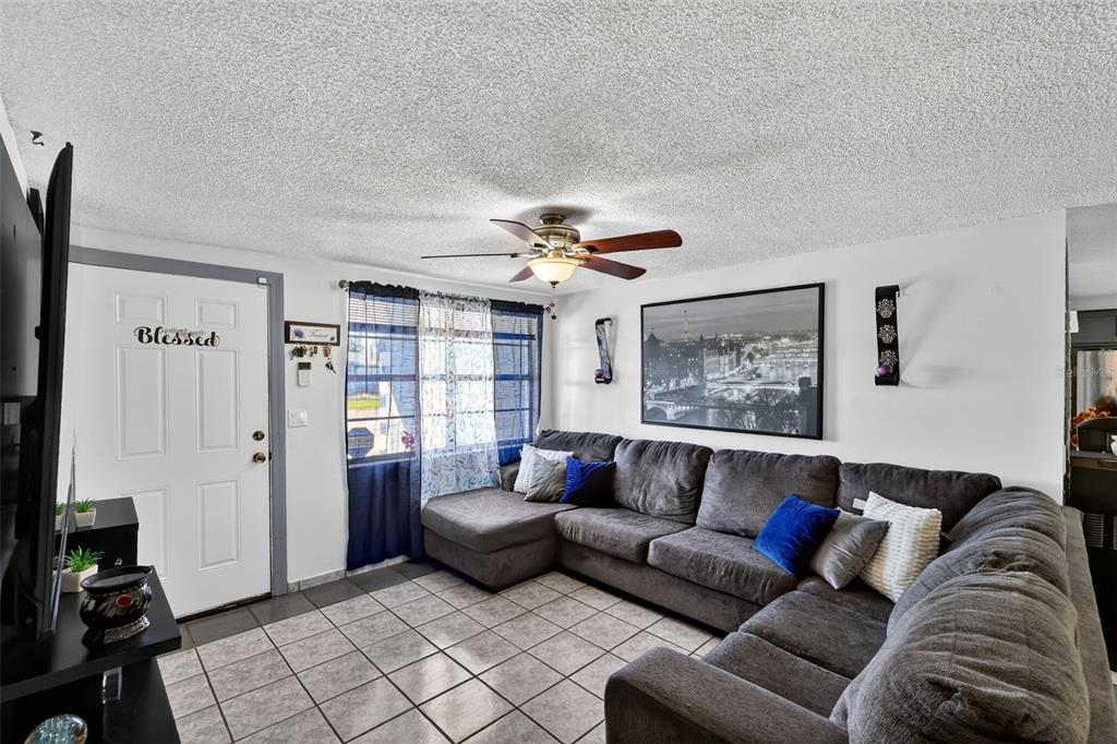 3837 Darlington Road Holiday, FL 34691 - Photo 4 of 28 a living room with furniture and a chandelier