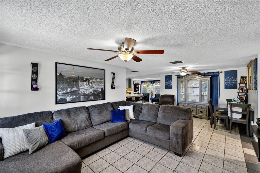 3837 Darlington Road Holiday, FL 34691 - Photo 6 of 28 a living room with furniture and a ceiling fan