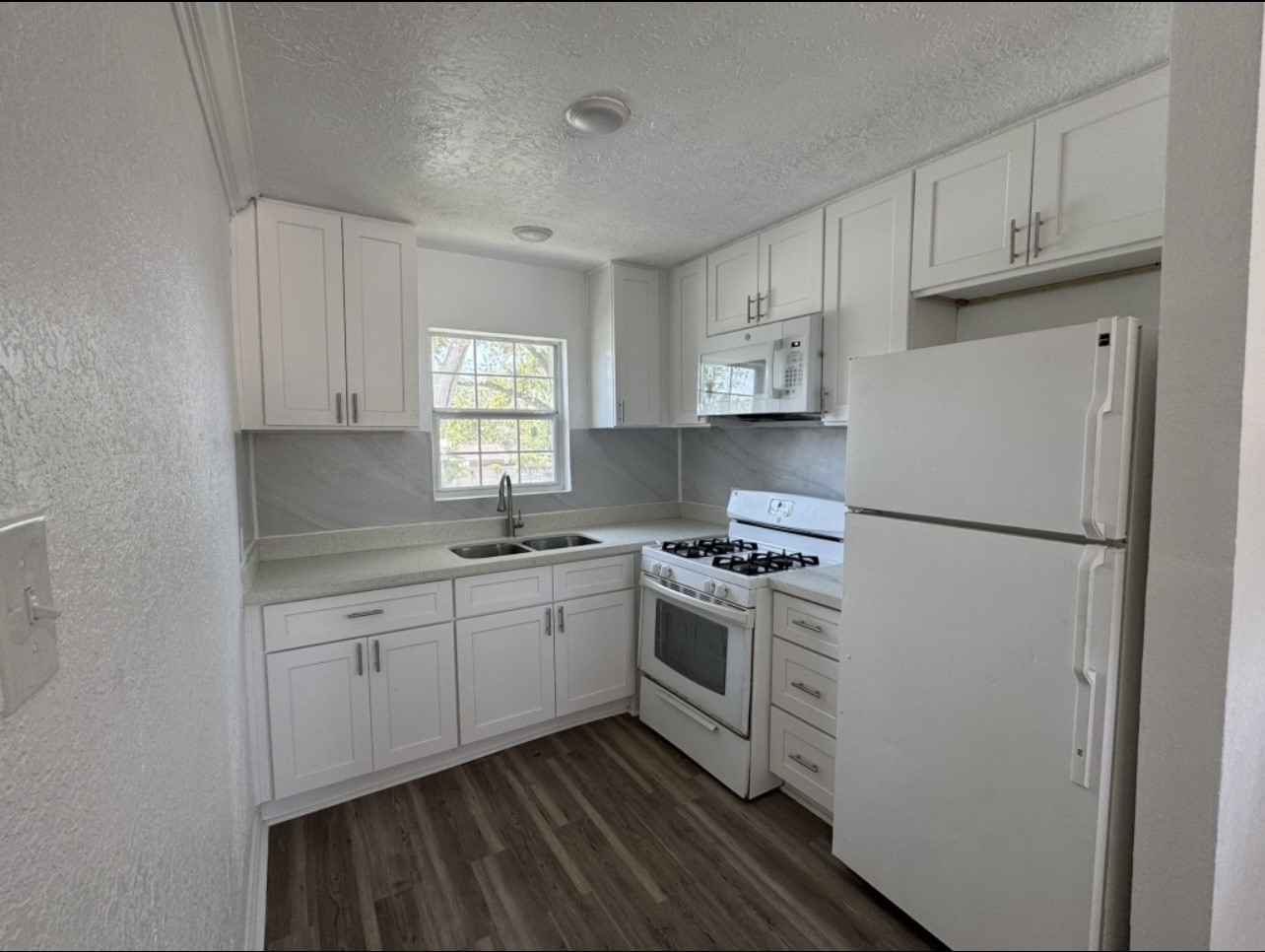923 Knight Street, Unit A2 Houston, TX 77022 - Photo 1 of 7 a kitchen with stainless steel appliances granite countertop a refrigerator sink and stove