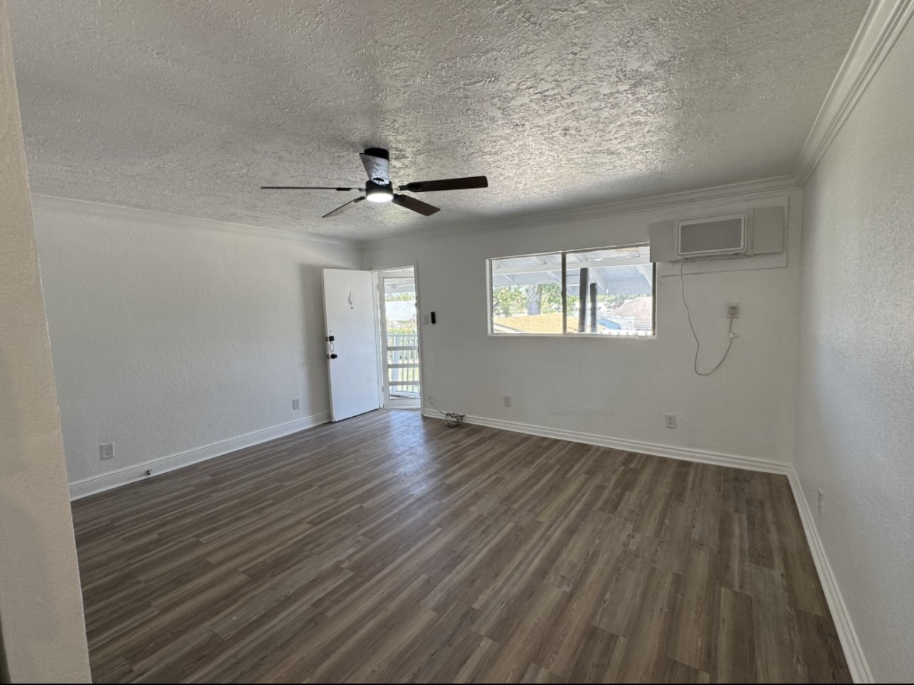 923 Knight Street, Unit A2 Houston, TX 77022 - Photo 3 of 7 wooden floor in an empty room with a window