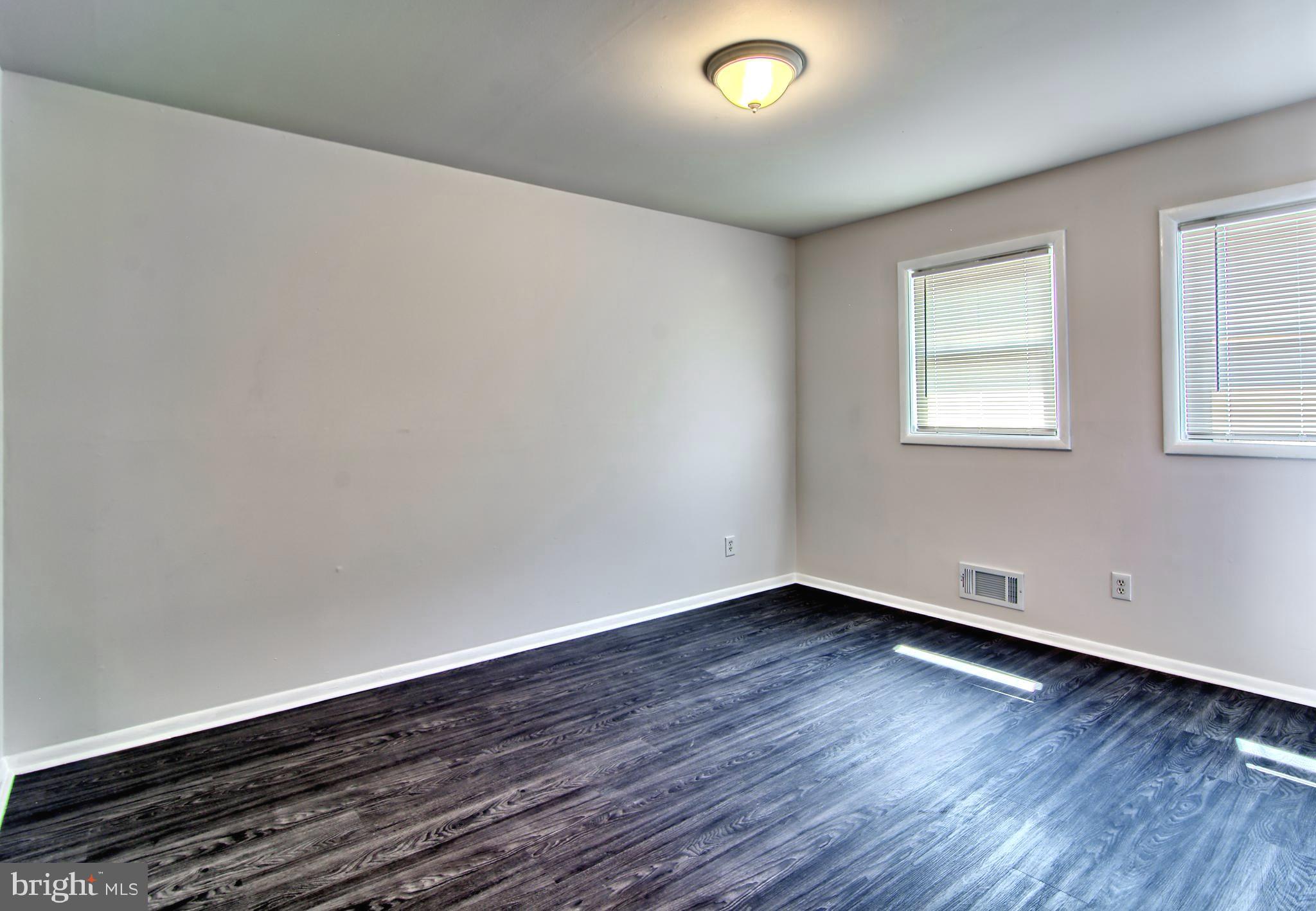 4214 Labyrinth Road Baltimore, MD 21215 - Photo 8 of 16 Primary Bedroom with New Flooring & Ceiling Light