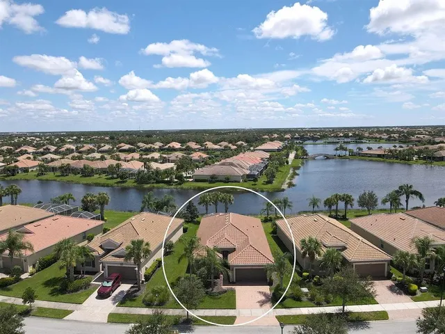 an aerial view of a house with outdoor space and lake view