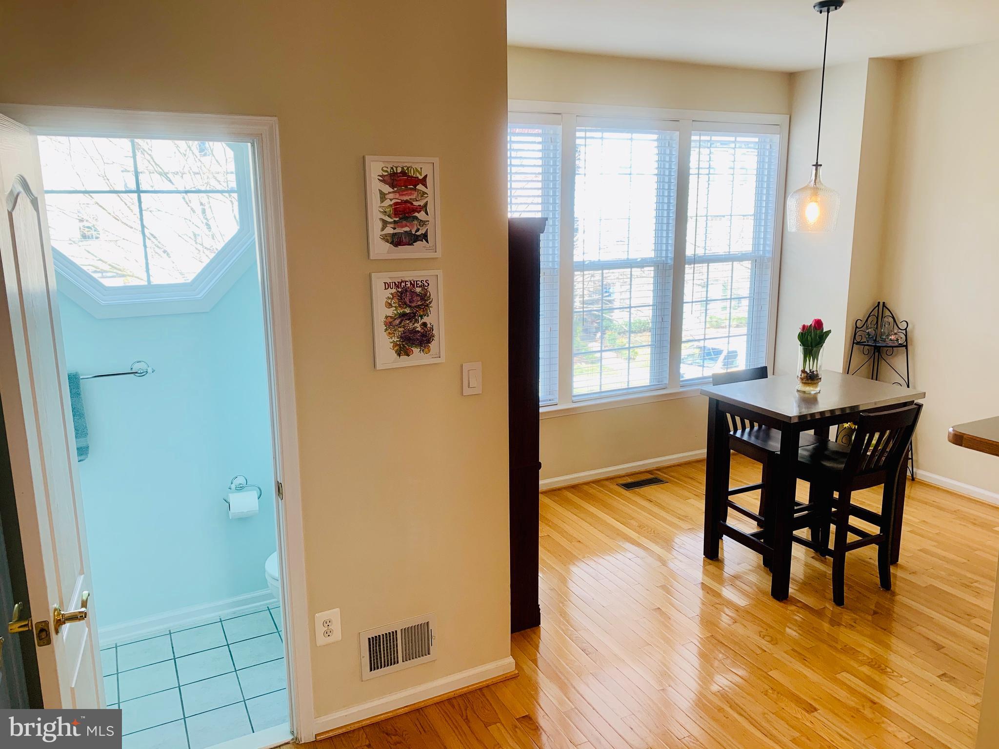 9823 Darcy Forest Drive Silver Spring, MD 20910 - Photo 11 of 32 a view of a dining room with furniture window and wooden floor