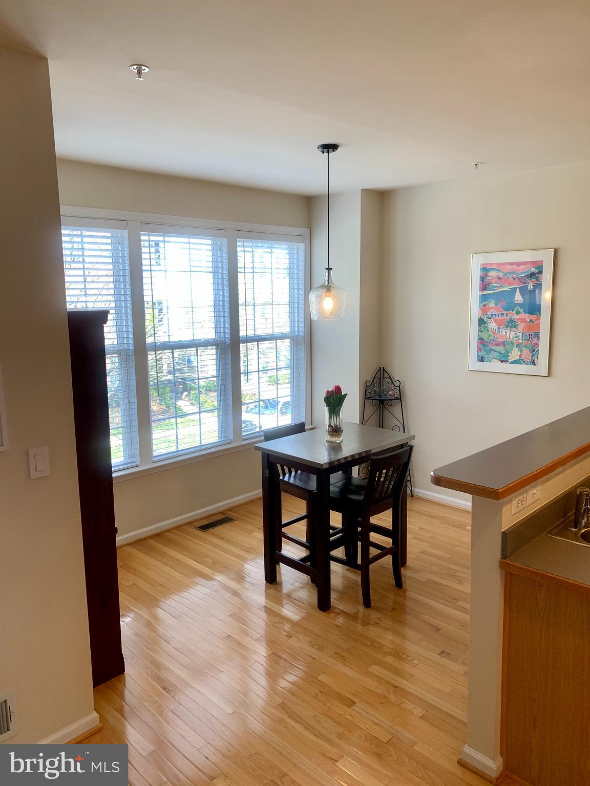 9823 Darcy Forest Drive Silver Spring, MD 20910 - Photo 12 of 32 a view of a dining room with furniture window and wooden floor