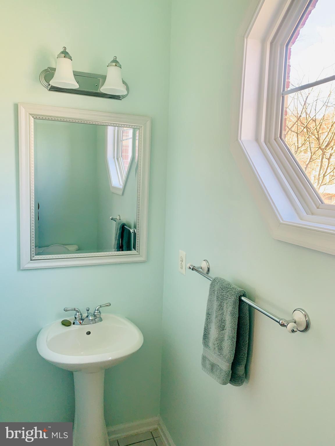 9823 Darcy Forest Drive Silver Spring, MD 20910 - Photo 13 of 32 a bathroom with a sink and a mirror