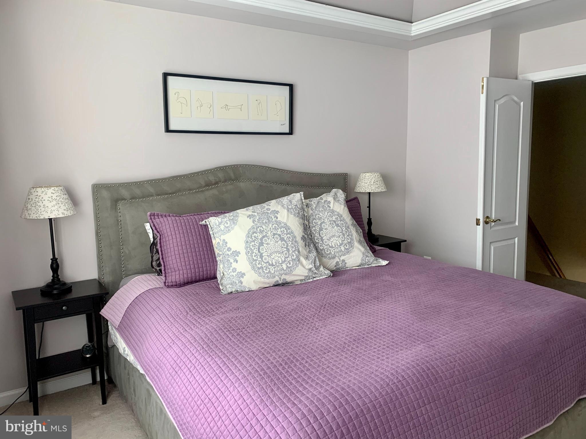 9823 Darcy Forest Drive Silver Spring, MD 20910 - Photo 19 of 32 a bedroom with a bed and a flat screen tv