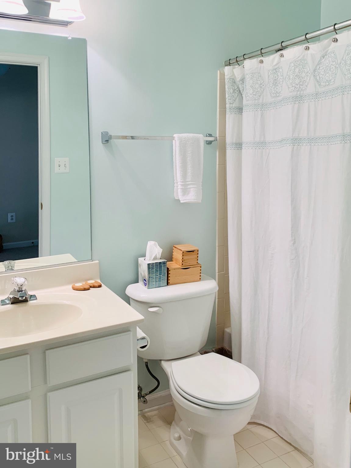 9823 Darcy Forest Drive Silver Spring, MD 20910 - Photo 24 of 32 a bathroom with a sink a toilet and a mirror