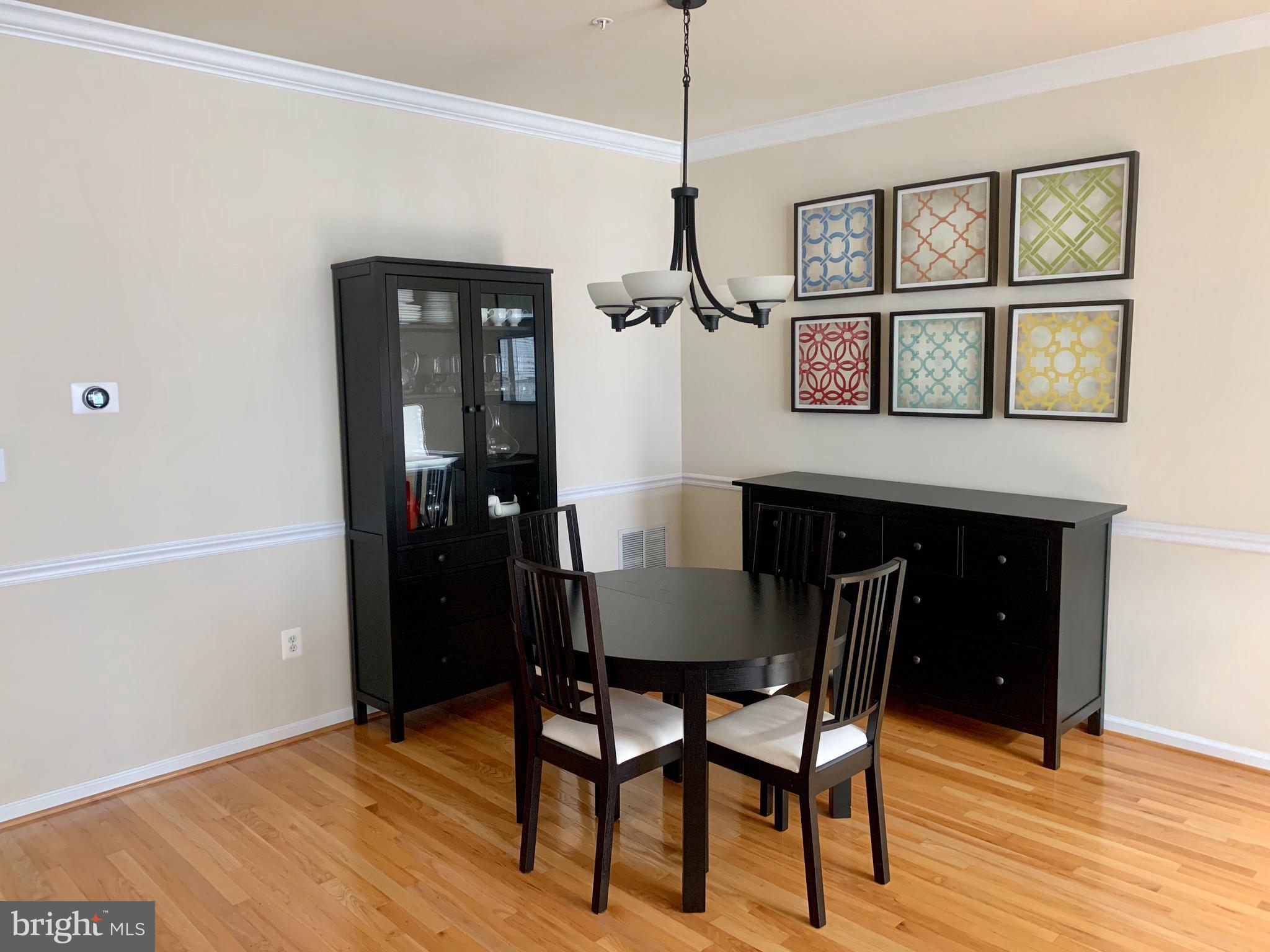 9823 Darcy Forest Drive Silver Spring, MD 20910 - Photo 8 of 32 a dining room with a wooden table and chairs