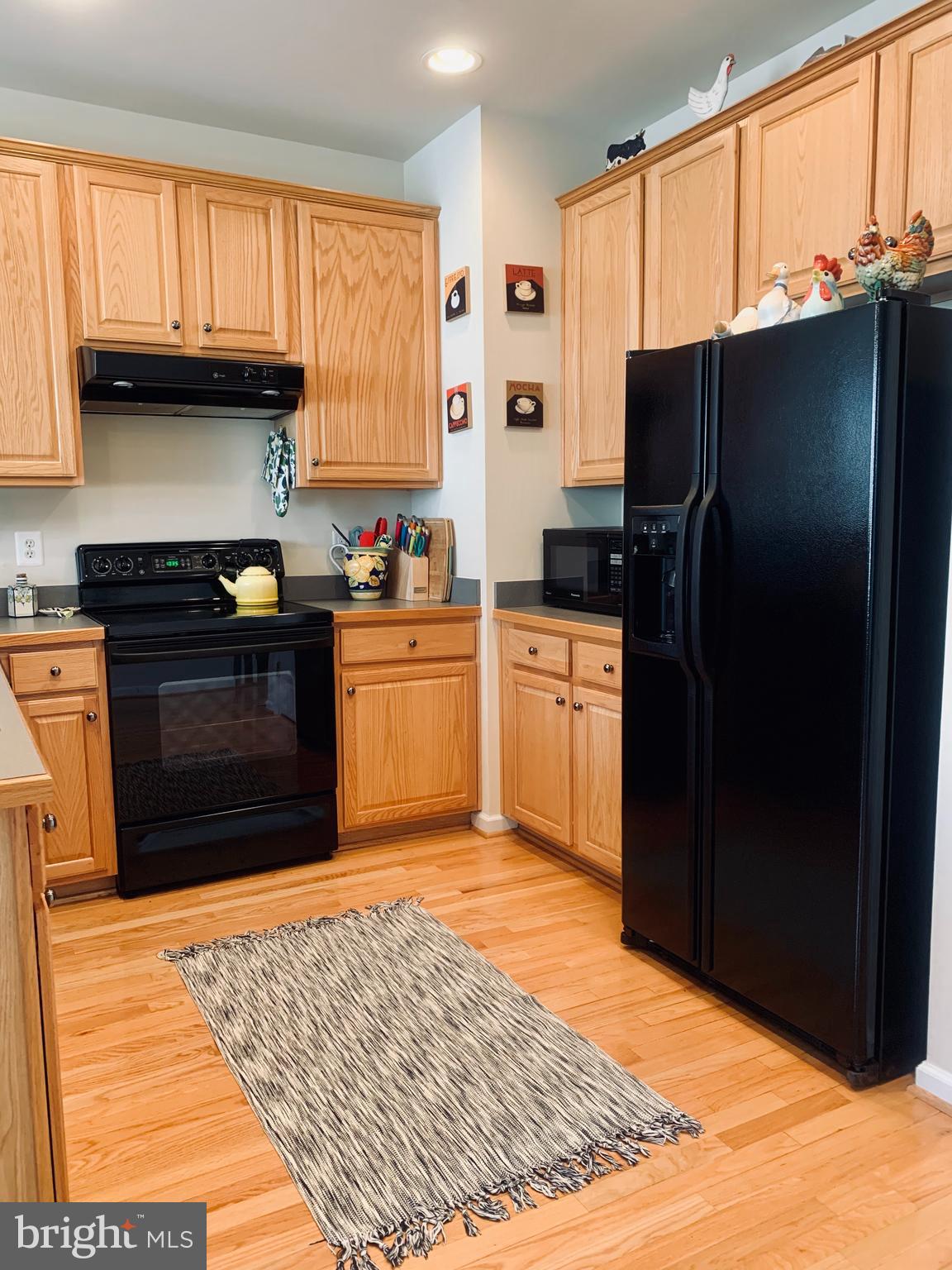 9823 Darcy Forest Drive Silver Spring, MD 20910 - Photo 10 of 32 a kitchen with granite countertop a refrigerator stove and oven
