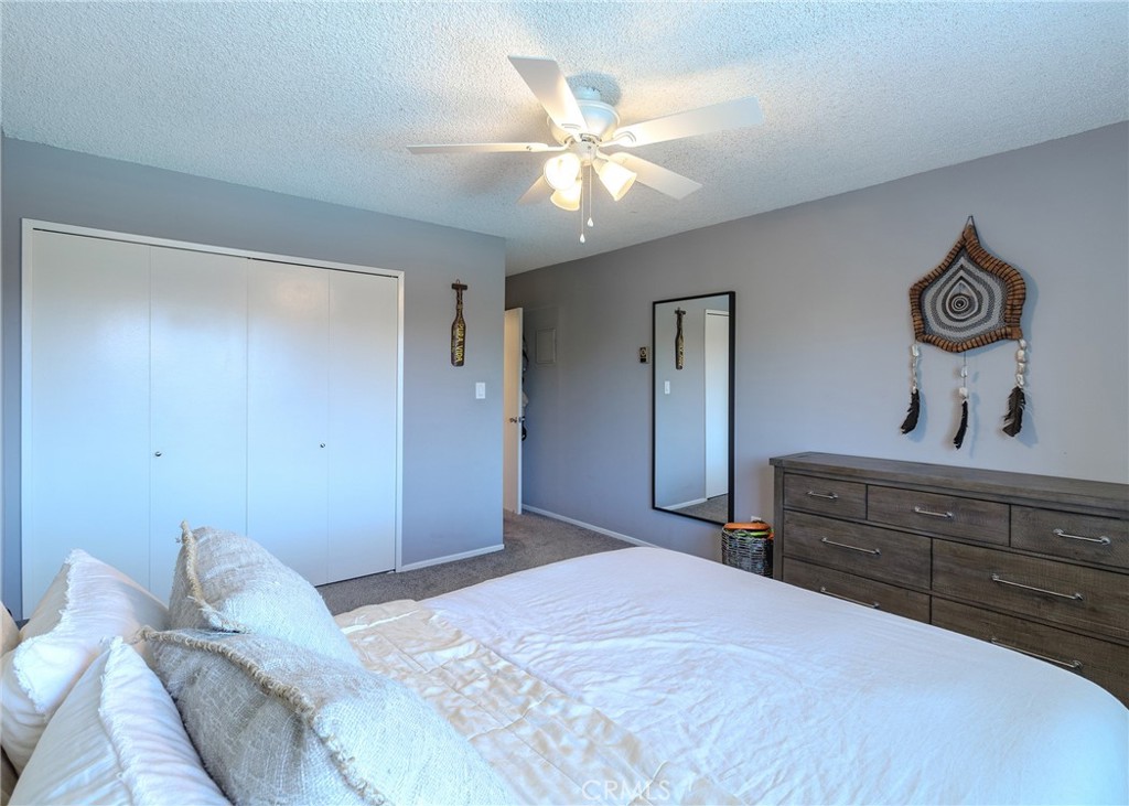 12200 Montecito Road, Unit D320 Seal Beach, CA 90740 - Photo 14 of 27 a bedroom with a bed and a chandelier