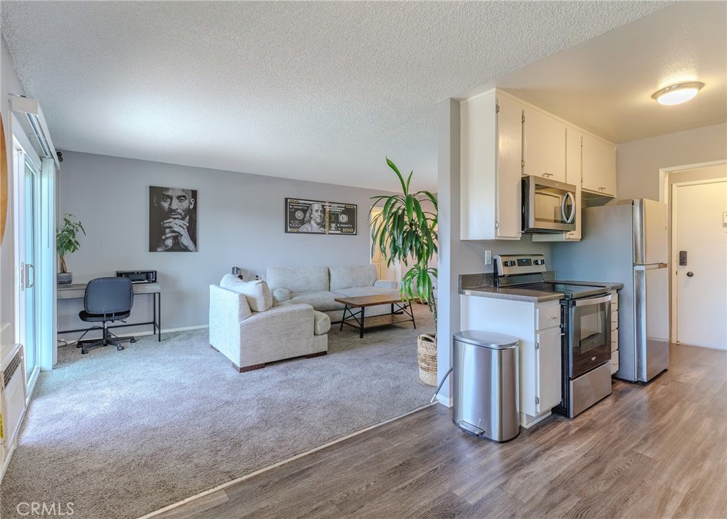 12200 Montecito Road, Unit D320 Seal Beach, CA 90740 - Photo 2 of 27 a living room with furniture wooden floor and a fireplace