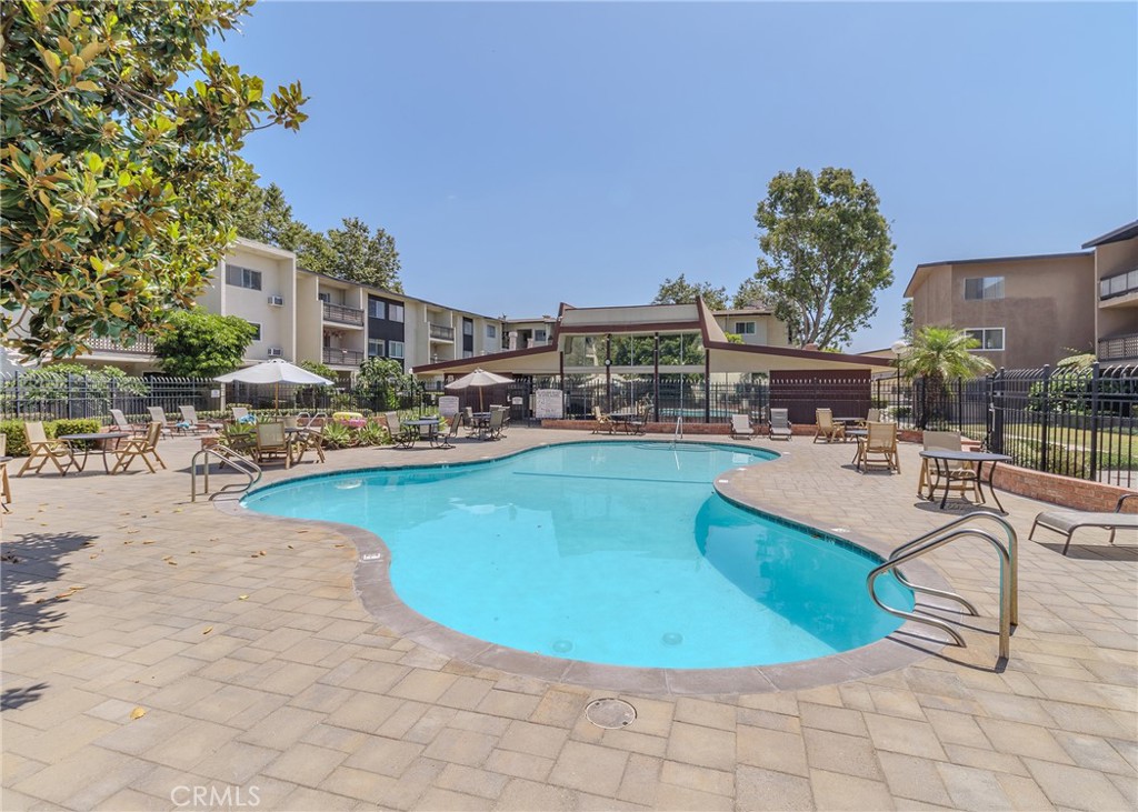12200 Montecito Road, Unit D320 Seal Beach, CA 90740 - Photo 22 of 27 a swimming pool with outdoor seating and yard