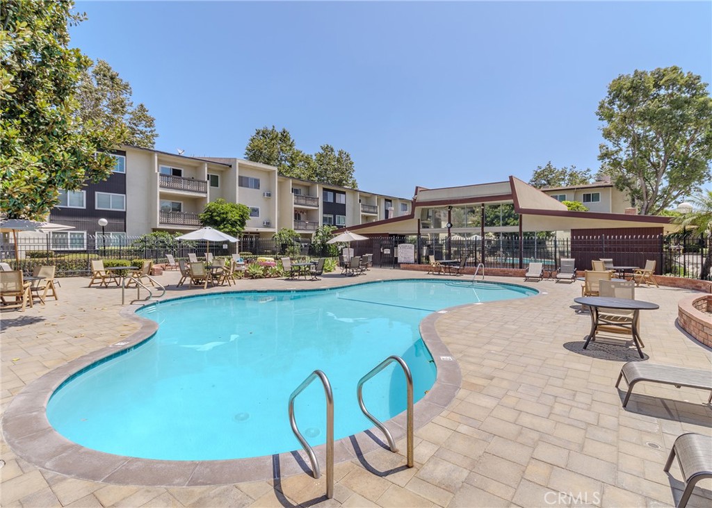 12200 Montecito Road, Unit D320 Seal Beach, CA 90740 - Photo 24 of 27 a swimming pool with outdoor seating and yard in the back