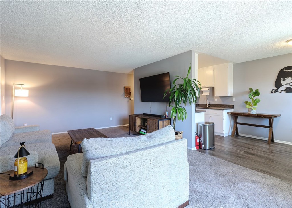 12200 Montecito Road, Unit D320 Seal Beach, CA 90740 - Photo 4 of 27 a living room with furniture and a flat screen tv