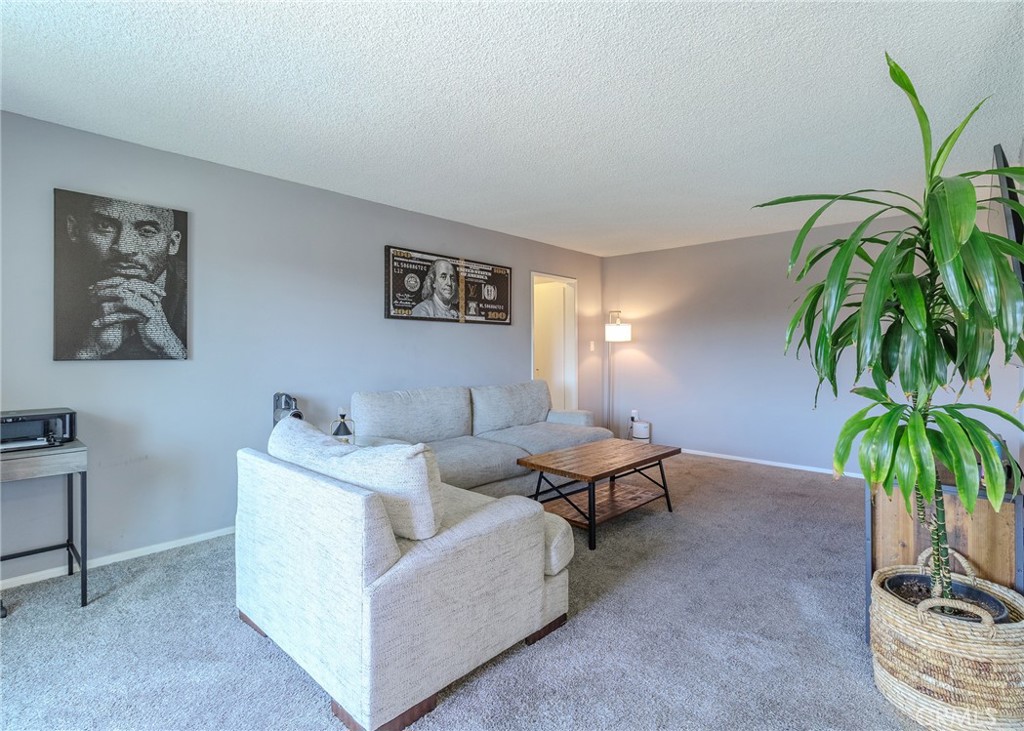 12200 Montecito Road, Unit D320 Seal Beach, CA 90740 - Photo 5 of 27 a living room with furniture and a potted plant