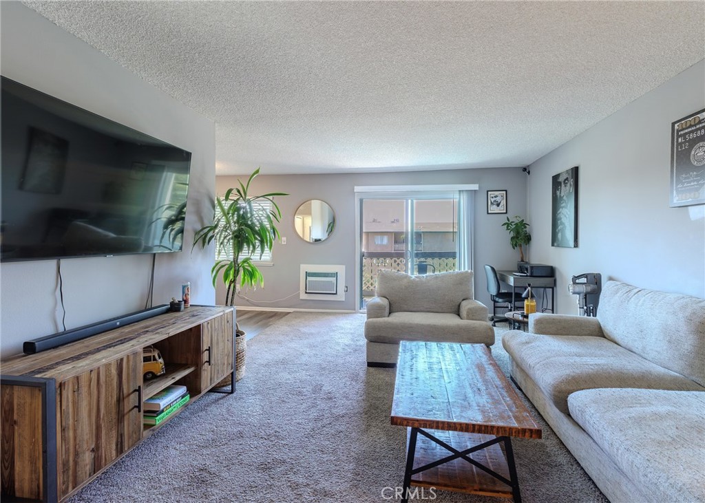 12200 Montecito Road, Unit D320 Seal Beach, CA 90740 - Photo 6 of 27 a living room with furniture and a flat screen tv