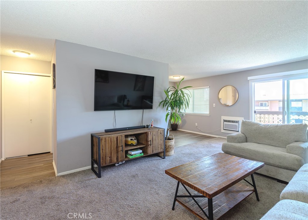 12200 Montecito Road, Unit D320 Seal Beach, CA 90740 - Photo 10 of 27 a living room with furniture and a flat screen tv