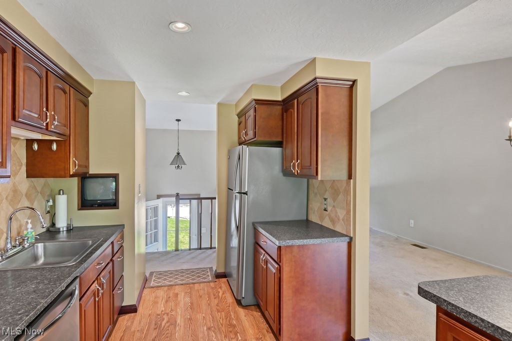 2610 Norton Road Stow, OH 44224 - Photo 13 of 41 Main level. Kitchen with a sink, appliances with stainless steel finishes, dark countertops, baseboards, and recessed lighting