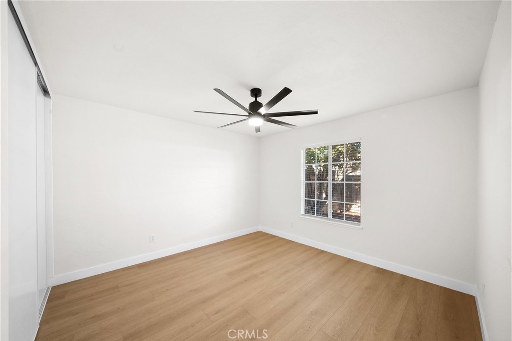 7931 Silverado Place Riverside, CA 92503 - Photo 28 of 35 an empty room with window and ceiling fan