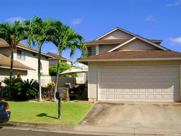 a view of a house with a yard and potted plants