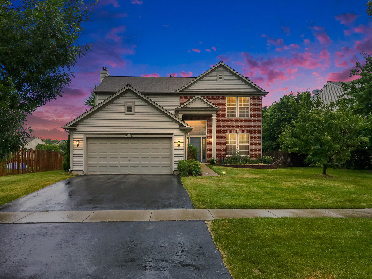 a front view of a house with a yard and garage