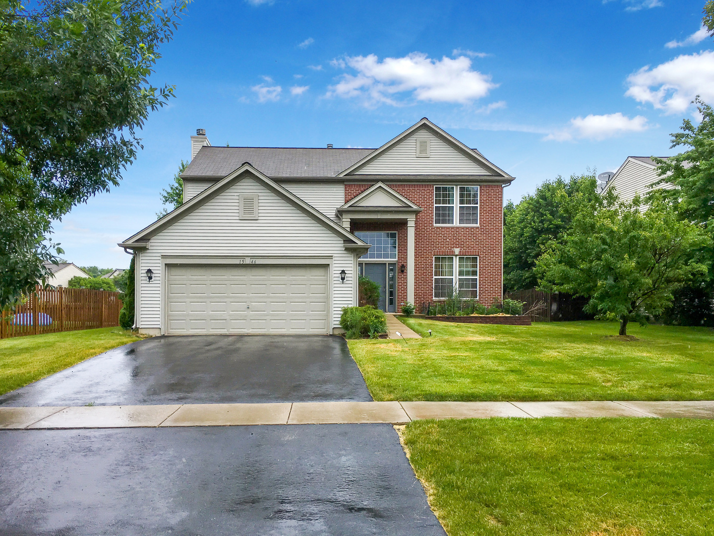 1546 Clear Drive Bolingbrook, IL 60490 - Photo 2 of 30 a front view of a house with a yard and garage