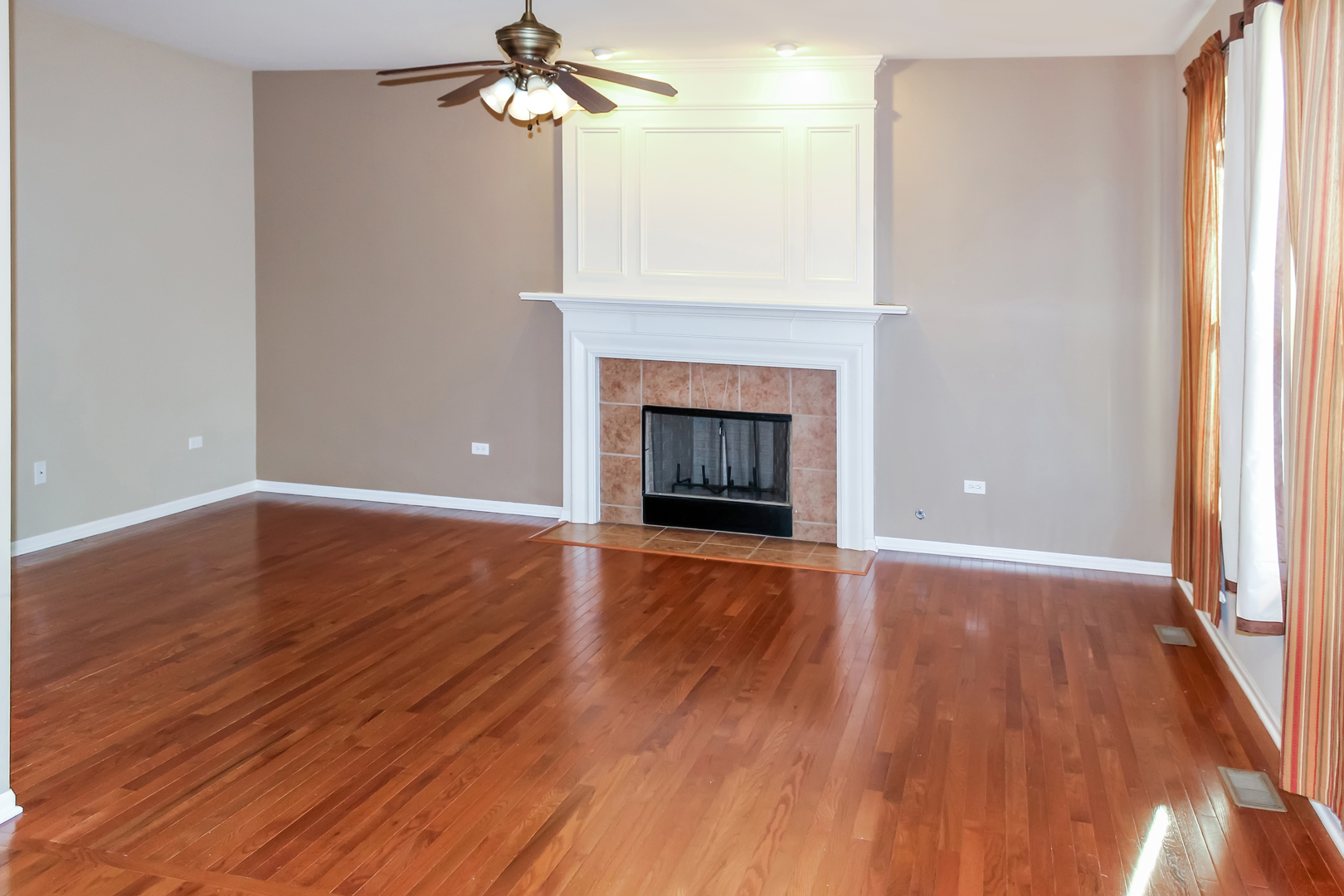 1546 Clear Drive Bolingbrook, IL 60490 - Photo 7 of 30 an empty room with wooden floor fireplace and windows