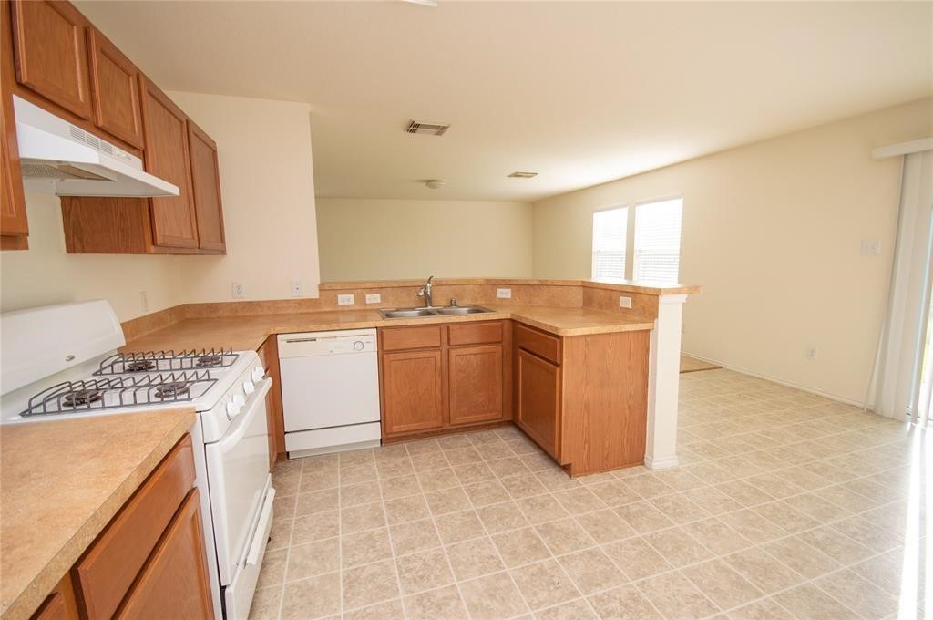 310 Falling Pine Drive Conroe, TX 77304 - Photo 6 of 15 a utility room with cabinets washer and dryer
