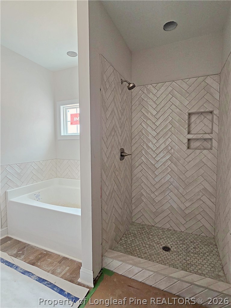 2678 Norrington Road Lillington, NC 27546 - Photo 15 of 31 a bathroom with a shower and a bath tub
