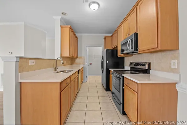 a kitchen with stainless steel appliances granite countertop a sink and a stove