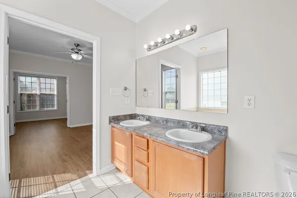 a bathroom with a granite countertop sink a mirror and a bathtub