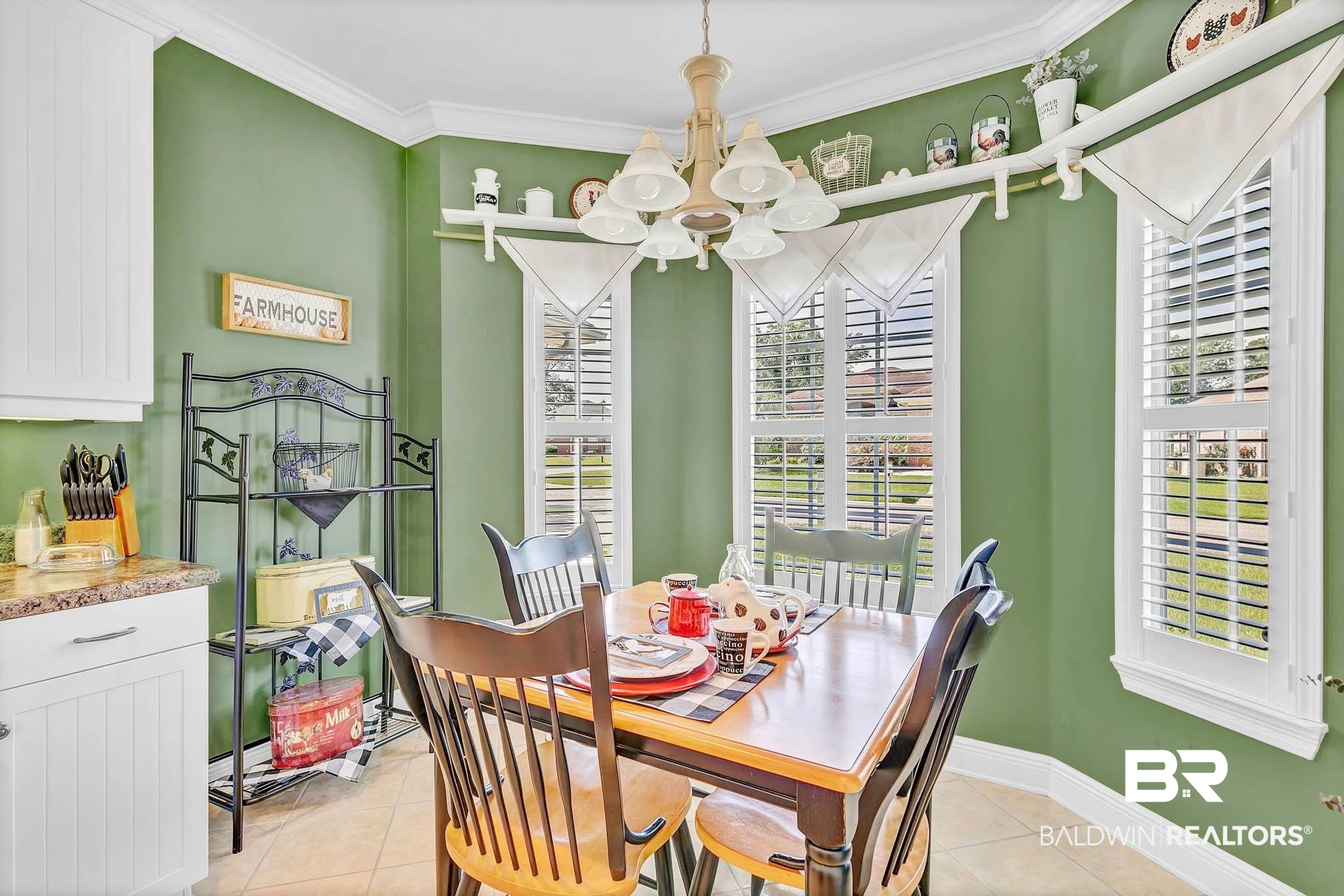 213 Hemingway Loop Foley, AL 36535 - Photo 25 of 69 Dining area with a chandelier, plenty of natural light, light tile patterned floors, and ornamental molding