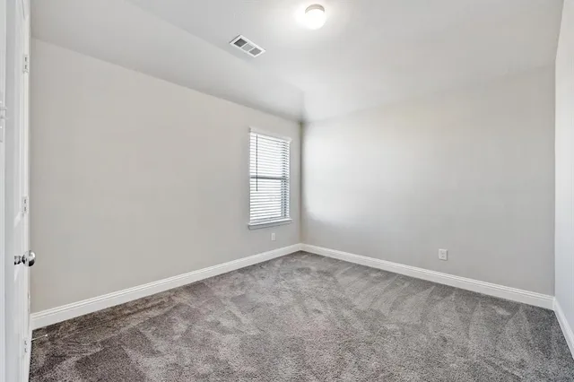 a view of a backyard with grass and wooden fence