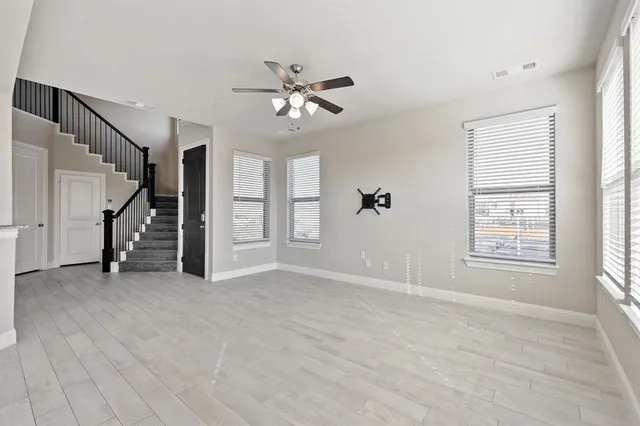 an empty room with windows and entryway