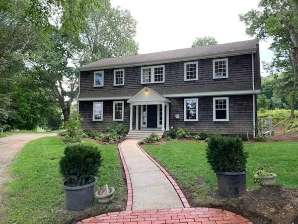 a front view of a house with a yard