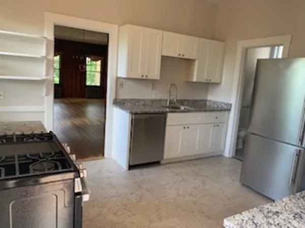a kitchen with a sink stove and refrigerator