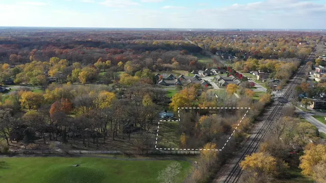 an aerial view of residential house with outdoor space and trees around