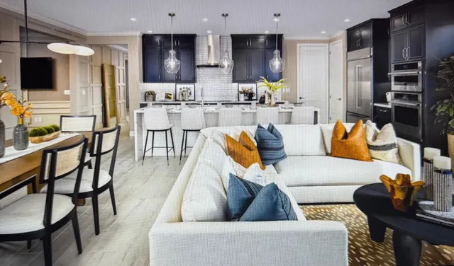 a living room with furniture and kitchen view