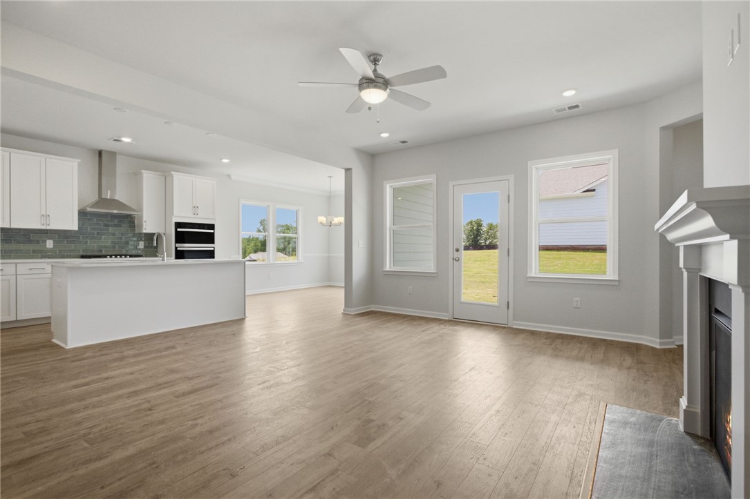 557 Hydrangea Street, Unit LOT 46 Seneca, SC 29678 - Photo 11 of 37 An open-concept living area with a sleek kitchen island and abundant natural illumination.