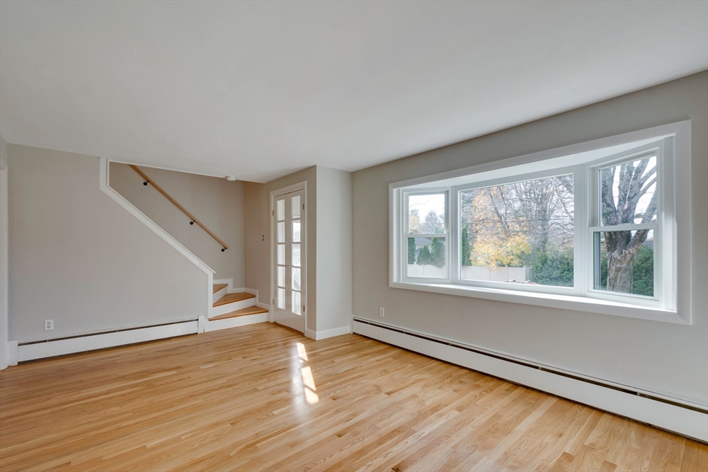 34 Irving Drive Walpole, MA 02081 - Photo 16 of 42 an empty room with wooden floor and windows