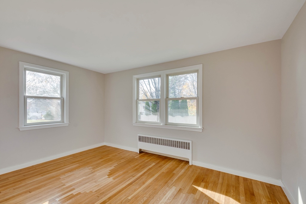 34 Irving Drive Walpole, MA 02081 - Photo 18 of 42 a view of an empty room with wooden floor and a window
