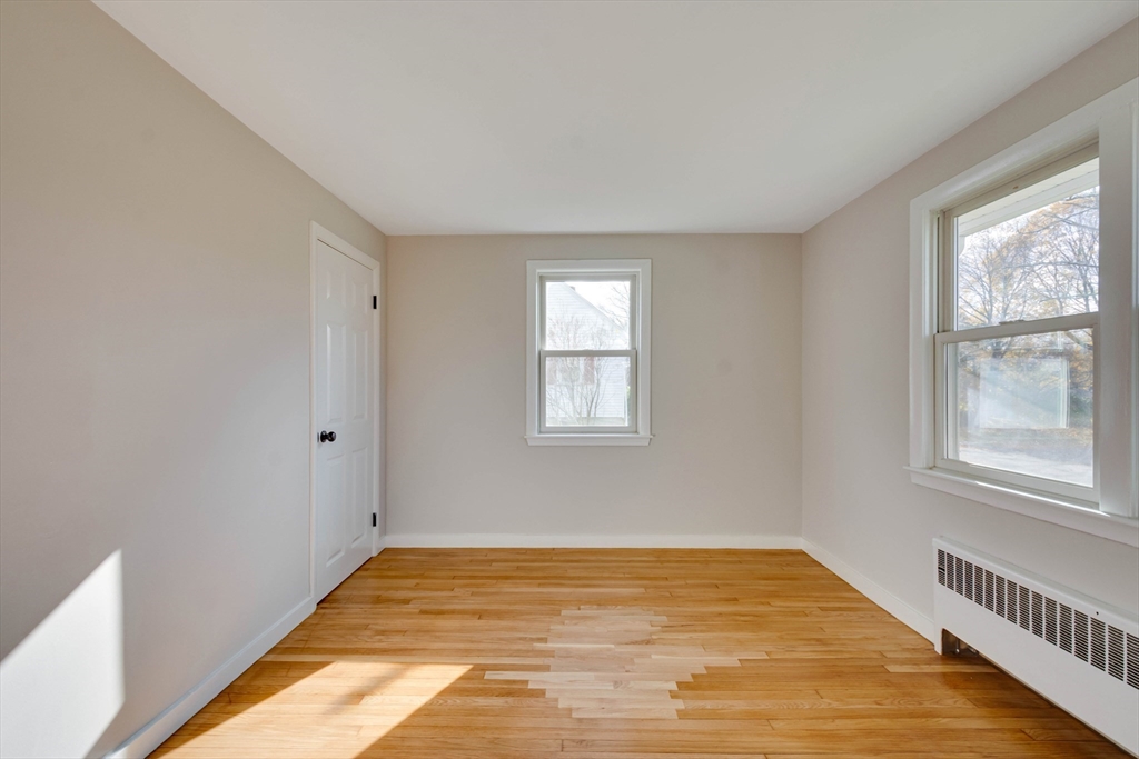 34 Irving Drive Walpole, MA 02081 - Photo 19 of 42 a view of an empty room with wooden floor and a window