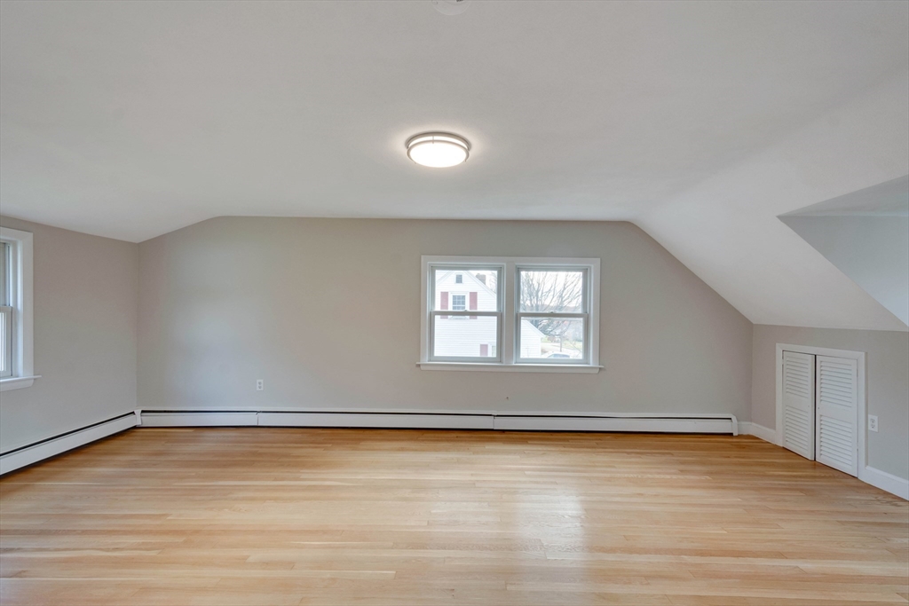 34 Irving Drive Walpole, MA 02081 - Photo 24 of 42 an empty room with wooden floor and windows