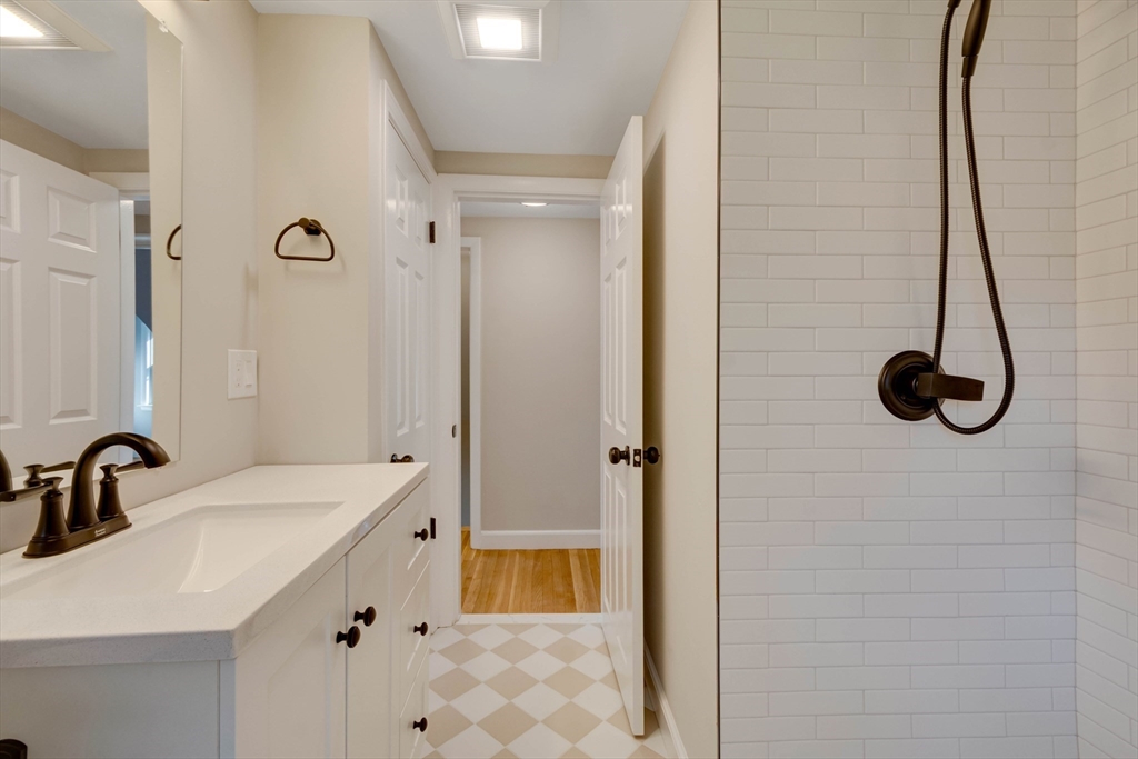 34 Irving Drive Walpole, MA 02081 - Photo 28 of 42 a bathroom with a sink and mirror