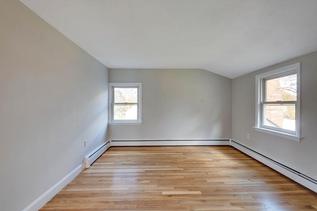 34 Irving Drive Walpole, MA 02081 - Photo 31 of 42 wooden floor in an empty room with a window